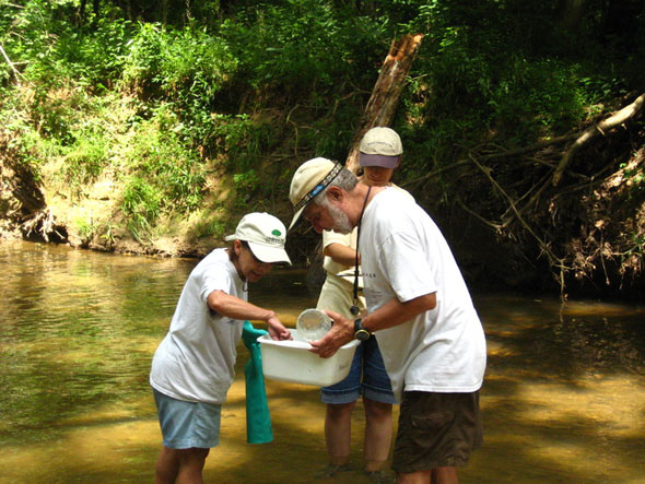 3 - Gretchen Schwartz  Katie Basiotis_ and Charlie Dorian examine the sample